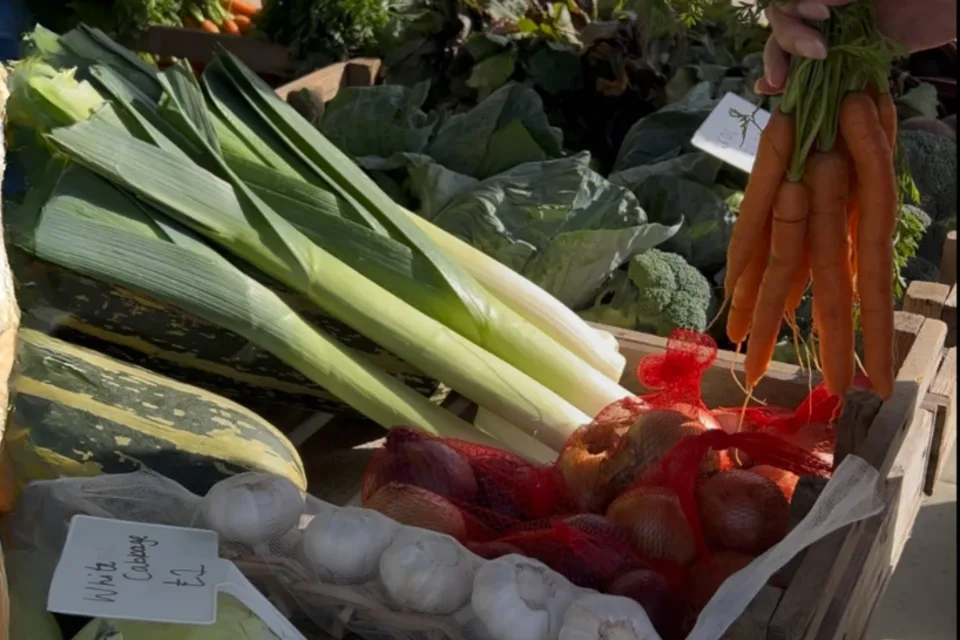 Leeks, cabbages, garlic and carrots on a produce stall